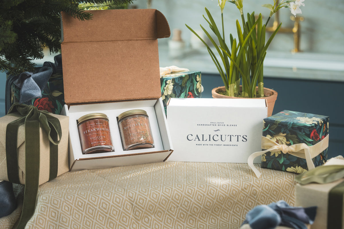 a box with jars of seasoning and a box with a plant in it