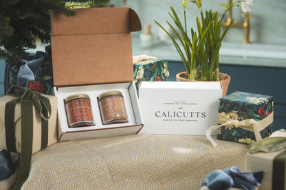 a box with jars of seasoning and a box with a plant in it